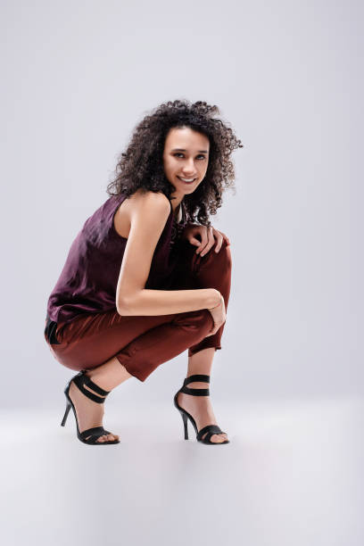istock Fashion model posing and smiling on white background 2174413447