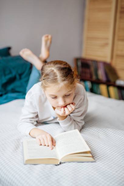 istock girl reading fiction 2174413990
