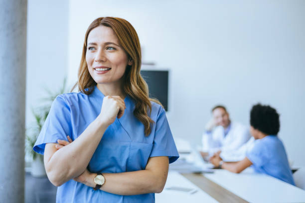 istock Confident nurse in blue scrubs smiling 2174418181
