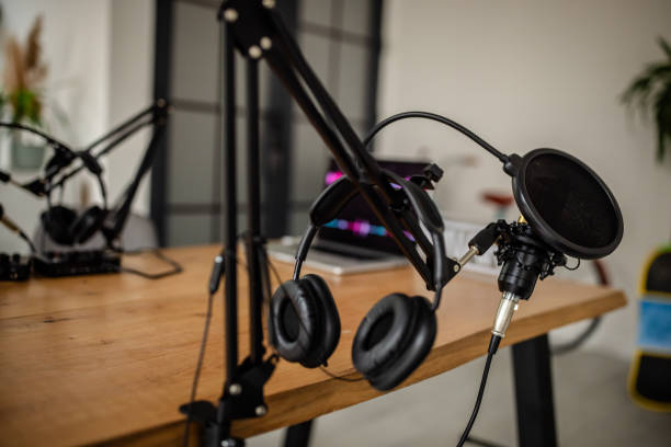 istock Microphone and headphones on a desk in podcast studio. 2174418892