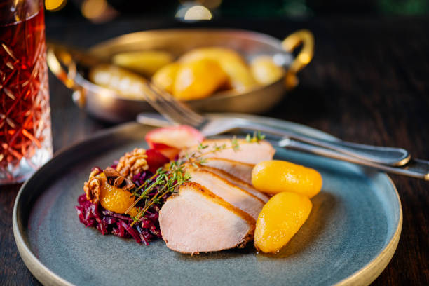 Traditional Christmas lunch in Denmark and other Scandinavian countries is roasted pork, here a pork loin, served with red cabbage and a Danish speciality of “brunede kartofler” These are small, round and firm potatoes that have been lightly boiled and peeled they are then placed in a large skillet and covered in a melted sugar and butter sauce to give them light brown colour and a delicious sweet taste. Please see my other pictures in this series.