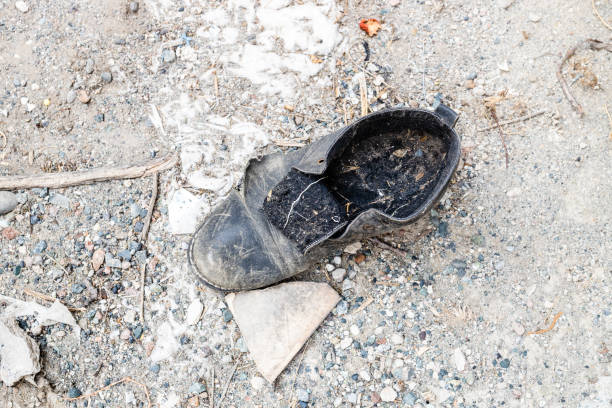 istock old torn discarded forgotten men's shoe 2174421039