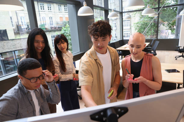 istock Business people looking at whiteboard during meeting 2174421552