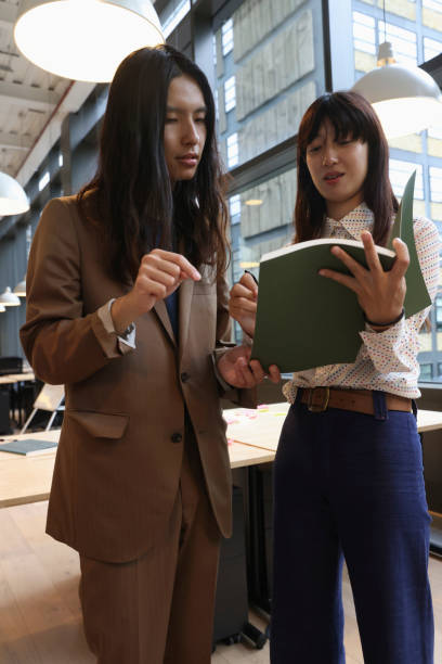 istock Business people looking at notes in office 2174422578