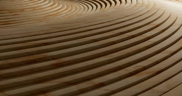 Close-up of multiple thin wooden strips coiled in concentric layers. The warm tones of the wood and the smooth texture create an intricate and aesthetically pleasing pattern
