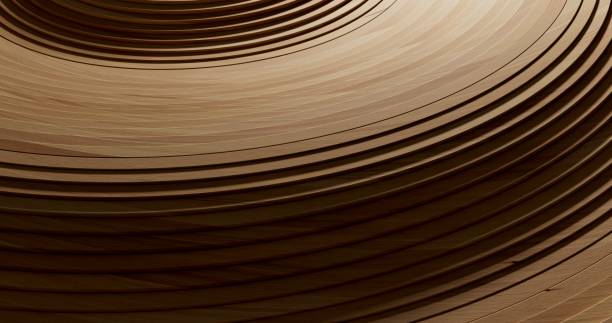 Close-up of slender wooden strips coiled into circular layers. The rich wood tones and sleek finish form a captivating and intricate pattern