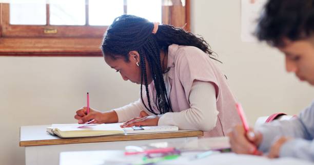 istock Writing, book and student in classroom for learning chemistry with notes for exam, test or project. Education, future and girl teenager in lesson for science at school academy with scholarship. 2174424555
