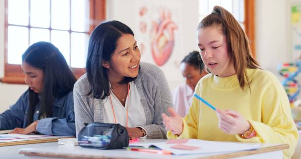 istock Happy teacher, student or girl with book for help, support or assistance on question at school. Young, female person or educator with learner or teenager for open exam, test or classroom assessment 2174424577