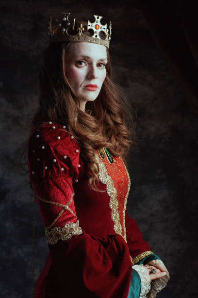 istock medieval queen in red dress with white makeup and crown 2174425563