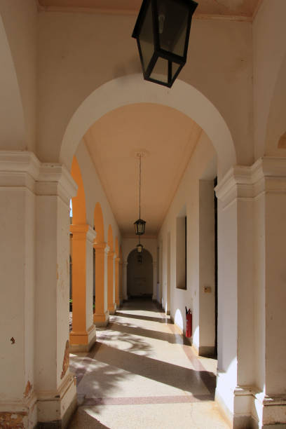 istock , airy corridor with elegant arches and columns, casting long shadows across the floor 2174425607