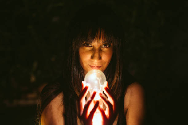 istock Thoughtful woman with burning lightbulb in darkness 2174426900