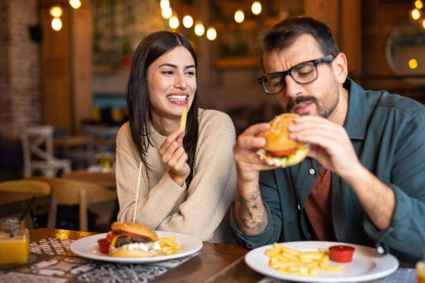 istock A man ready to take the first bite of his delicious hamburger 2174427301
