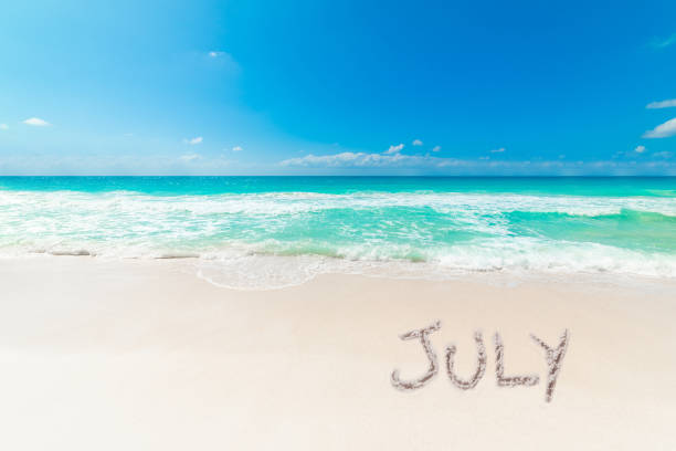 istock Tropical beach with July written on the sand 2174427356