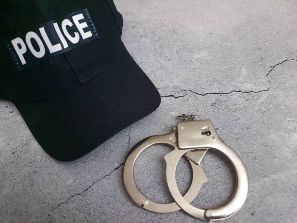 istock Police cap with handcuffs 2174427442