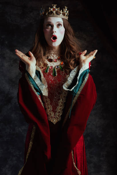 istock shocked medieval queen in red dress with white makeup 2174427468