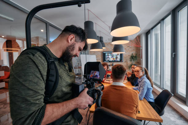 istock Capturing Corporate Dynamics: Videographer Films Business Meeting in Modern Office. 2174428773