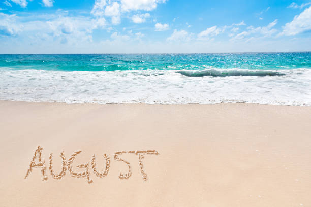 istock August written on a tropical beach with golden sand 2174429638