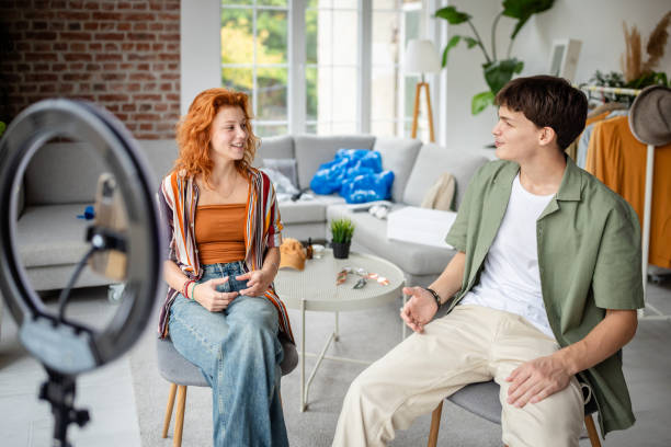 istock Two people in casual setting, preparing for online content. 2174429651