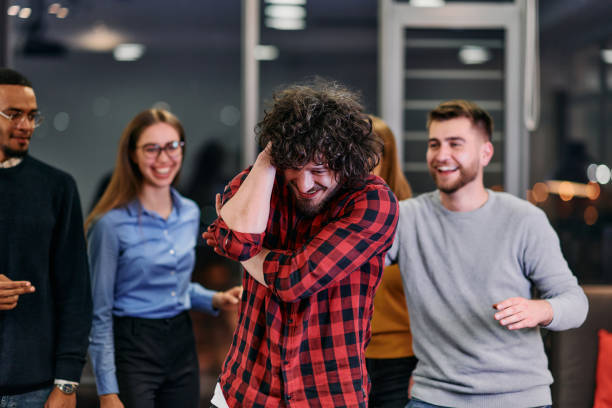 istock A group of young business people have fun playing interesting games while taking a break from work in a modern office. Selective focus 2174430069