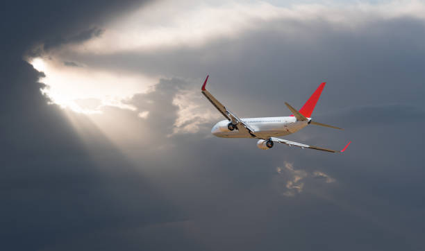 istock Airplane flying over tropical sea at sunset 2174430648