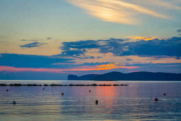 Cloudy sky over Capo Caccia at sunset. Sardinia, Italy