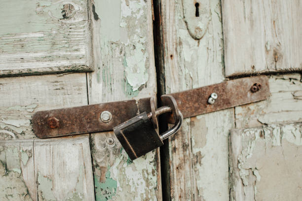 istock Boarded up old wooden door with padlock 2174431805