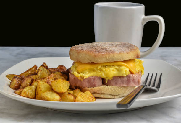 spam, scramble egg and  cheese on a english  muffin  served with home fries and coffee
