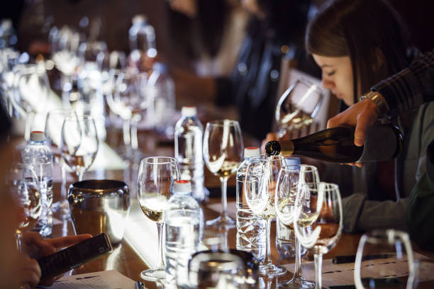 istock Puring White Wine into Glass During Elegant Wine Tasting Event Showcasing New Varietals at Dimly Lit Venue. 2174432782