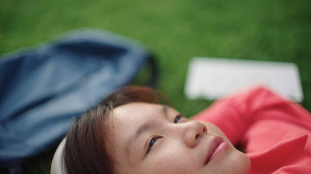 Asian young woman resting at park.