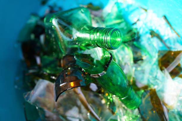 Broken glass bottles, background, texture. Broken glass bottles for recycling. Background of broken glass for recycle. Recyclable garbage, recovery of waste. Broken glass Waste Recycled.