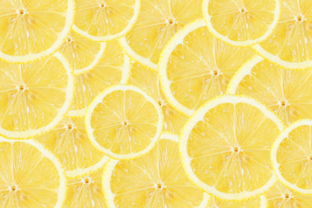 istock Yellow lemon slices background. Fruit pattern. Cut slices color texture. 2174443110