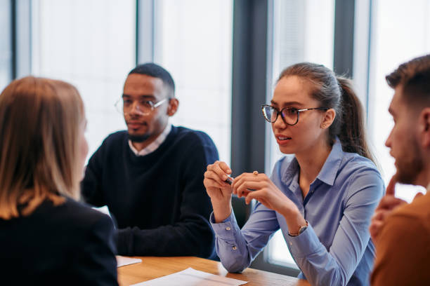 istock Businesswoman Leading Discussion in Modern Office Setting 2174443737