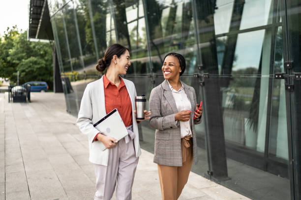istock Two business women walking together and talking 2174443927
