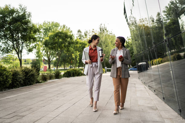 istock Two business women walking together and talking 2174444090