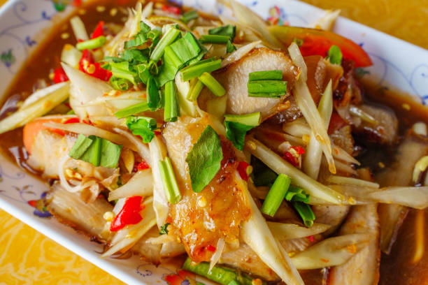 Closeup Thai food papaya salad with grilled pork neck on whitebackground isolation clippingpath.Isan Thai food is popular in Asia.