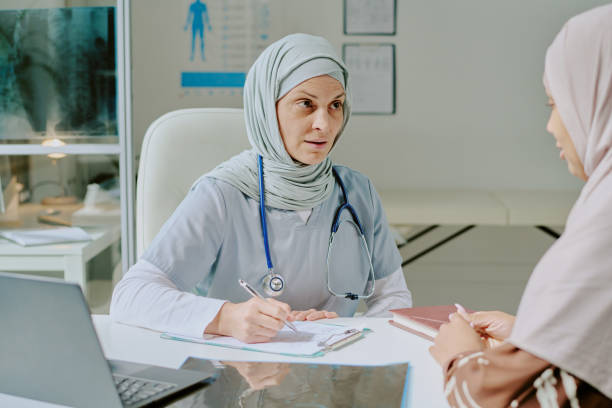 istock Doctor Wearing Hijab Discussing With Patient in Office 2174448998