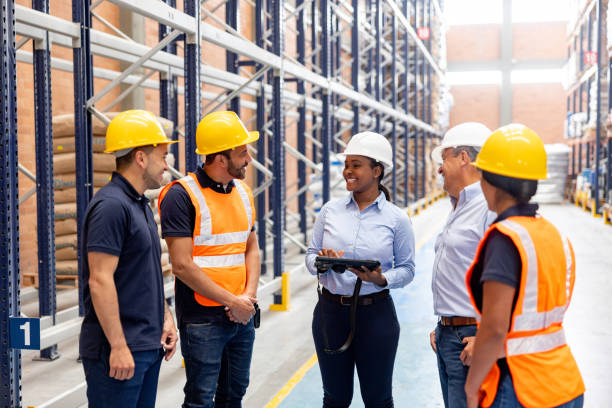 istock Female boss giving instructions to employees at a distribution warehouse 2174449732