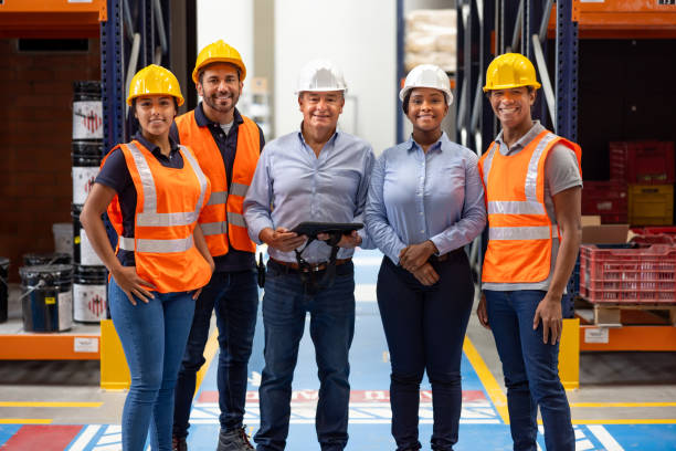 istock Team of warehouse workers smiling at the camera while working together 2174449748