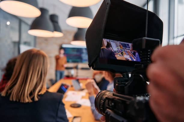 istock Capturing Corporate Dynamics: Videographer Films Business Meeting in Modern Office. 2174451194