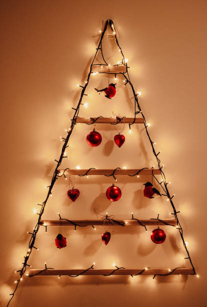 istock Alternative christmas tree from wood decorated with lights and ornaments 2174451220