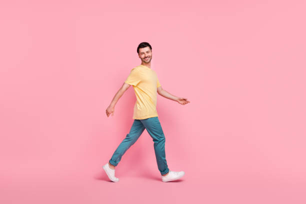istock Full length photo of optimistic attractive man dressed comfort clothes going moving empty space isolated on pink color background 2174451596