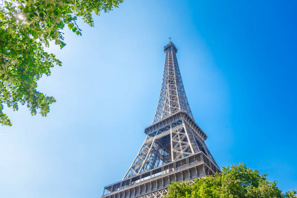 istock World famous Eiffel tower surrounded by green trees under a clear sky 2174452395