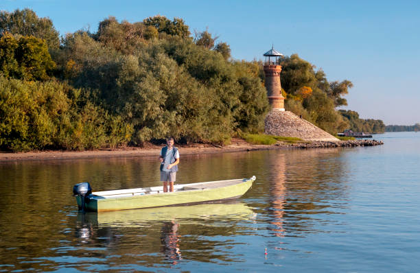 People ride a speedboat in the city park of Uralsk. A white speedboat rushes at speed along the Chagan River