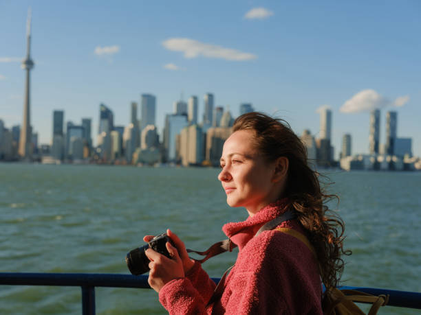 istock Woman photographing with camera on Toronto Island 2174457961