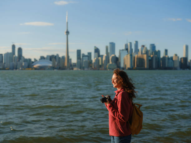istock Woman photographing with camera on Toronto Island 2174458087