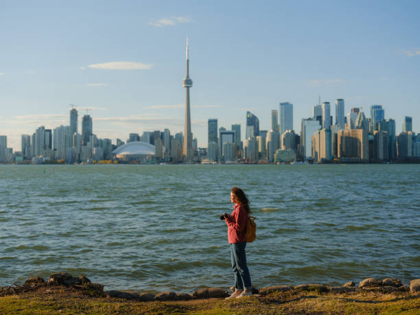 istock Woman photographing with camera on Toronto Island 2174458092