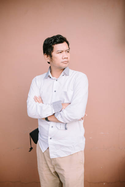 istock A man with a neutral expression facing forward, embodying a sense of calm and introspection in a simple yet captivating image 2174460720