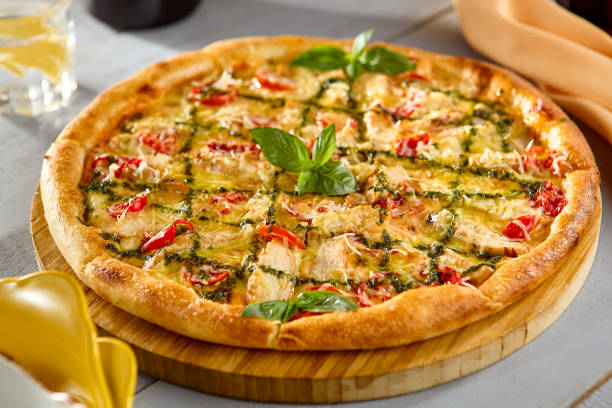 istock Delicious Chicken Pesto Pizza with Fresh Basil and Tomatoes 2174462423