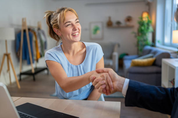 istock A young entrepreneur happily extends her hand to her advisor after a productive meeting. 2174463446