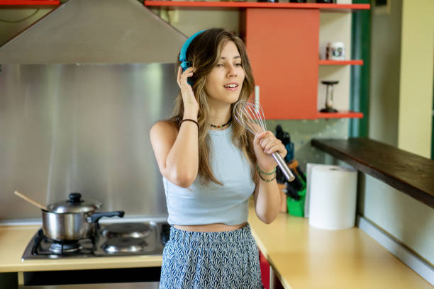 istock A young  happy student is singing in the kitchen 2174465423
